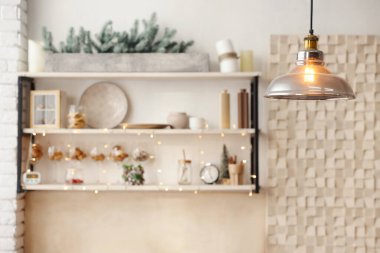 Kitchen interior with Christmas decor, focus on pendant lamp. Space for text