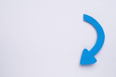 Paper curved arrow on white background, top view. Space for text