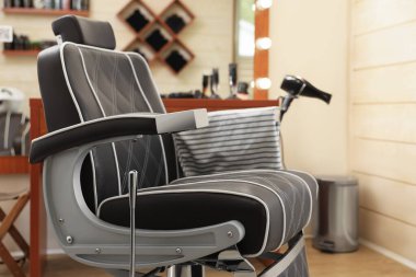 Professional barber chair in modern hairdressing salon