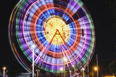 Beautiful glowing Ferris wheel against dark sky