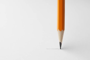 Drawing with sharp graphite pencil on white sheet of paper, closeup. Space for text