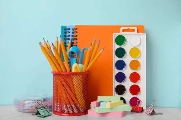 Different school stationery on table against light blue background. Back to school