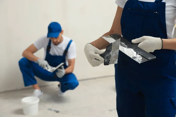Professional Workers Putty Knives Wall Indoors Closeup — Stockfoto
