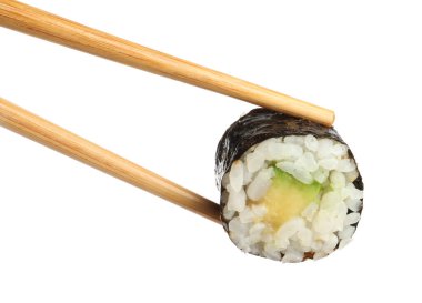 Chopsticks with tasty fresh sushi roll isolated on white