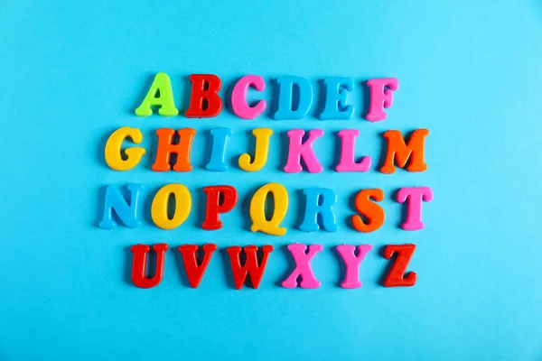 Many Colorful Magnetic Letters Light Blue Background Flat Lay Alphabetic — Stock Photo, Image