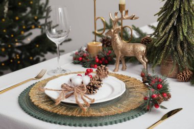 Luxury festive place setting with beautiful decor for Christmas dinner on white table indoors