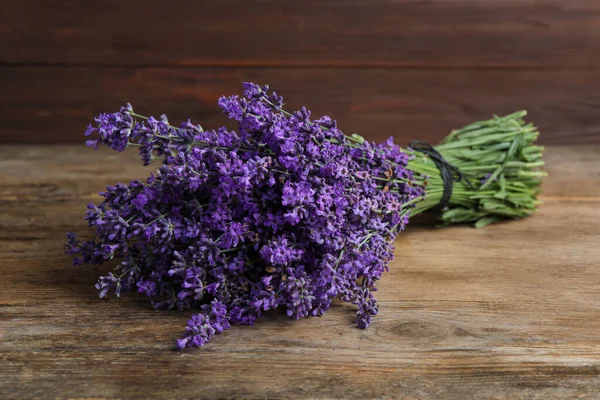 Beautiful fresh lavender bouquet on wooden table