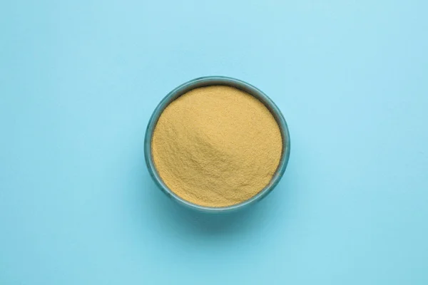 Beer yeast powder on light blue background, top view