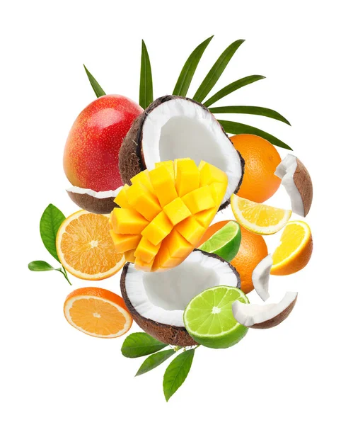 Different fresh fruits and leaves flying on white background