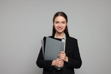 Gri arka planda güzel genç öğretmenin portresi