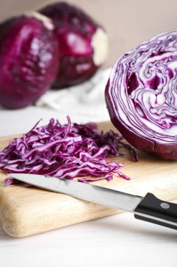 Cut fresh red cabbage on white wooden table