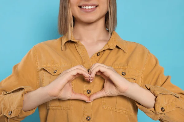 Young Woman Making Heart Hands Turquoise Background Closeup Volunteer Concept — Stockfoto