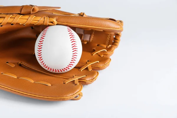 Catcher\'s mitt and baseball ball on white background, space for text. Sports game
