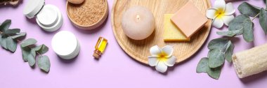 Spa treatment. Flat lay composition with spa cosmetic products on violet background. Banner design