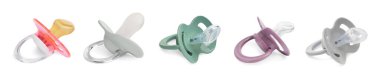 Set of different baby pacifiers on white background