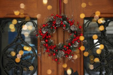 Beautiful Christmas wreath hanging on wooden door