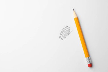 Sharp graphite pencil with eraser and hand drawn scribble on white sheet of paper, top view. Space for text