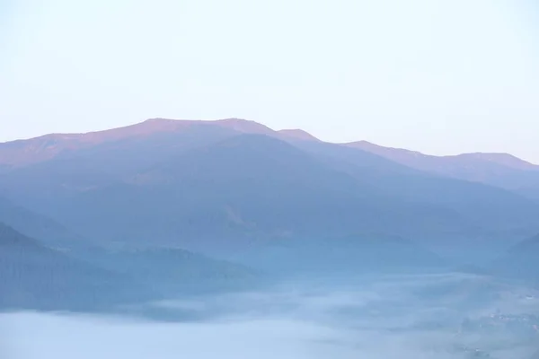 Beautiful view of fog in mountains during sunrise