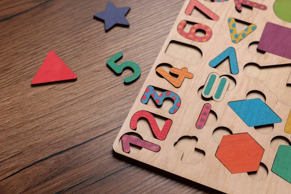 Math game kit for children on wooden table, closeup