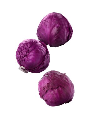 Delicious raw red cabbages falling on white background