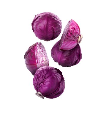 Delicious raw red cabbages falling on white background