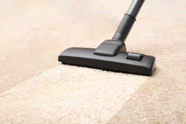 Vacuuming carpet. Clean area after using device, closeup