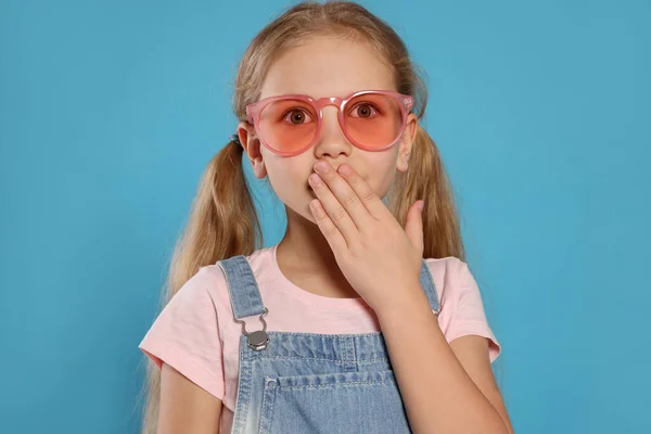 Girl Pink Sunglasses Covering Mouth Hand Light Blue Background — 스톡 사진