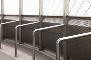 Enclosed observation deck equipped with metal handrails, closeup