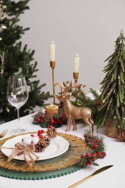 Luxury festive place setting with beautiful decor for Christmas dinner on white table indoors