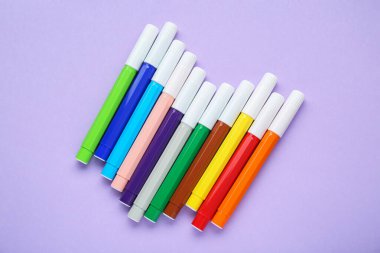 Different colorful markers on light background, flat lay