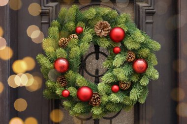 Beautiful Christmas wreath hanging on wooden door