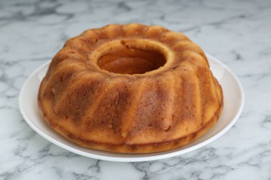 Homemade yogurt cake on white marble table