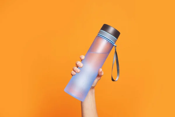 Woman Holding Bottle Water Orange Background Closeup —  Fotos de Stock