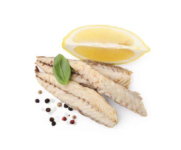 Canned mackerel fillets with lemon, basil and spices on white background, top view