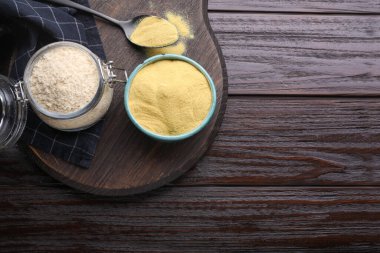 Granulated brewer`s yeast on wooden table, flat lay. Space for text