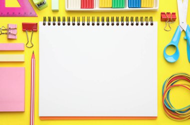 Flat lay composition with different school stationery on yellow background, space for text. Back to school