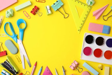 Frame made of different school stationery on yellow background, flat lay with space for text. Back to school