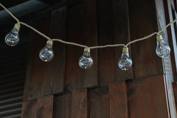 Beautiful garland of lamp bulbs hanging outdoors. String lights