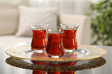 Glasses with traditional Turkish tea on table indoors