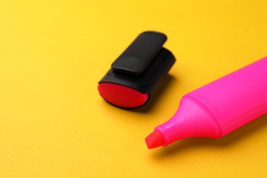 Bright marker on orange background, closeup. Space for text