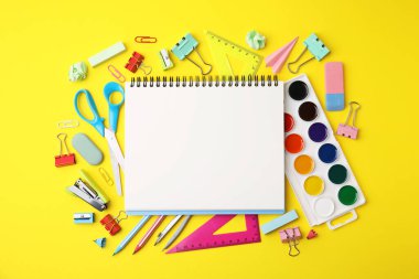 Flat lay composition with different school stationery on yellow background, space for text. Back to school