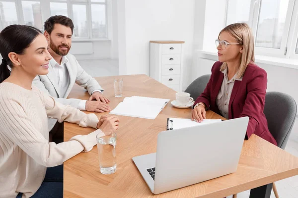 Real estate agent working with couple in new apartment