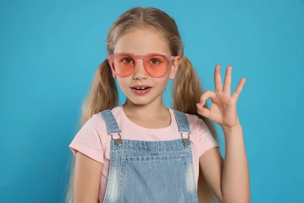 Girl Pink Sunglasses Showing Gesture Light Blue Background — Fotografia de Stock