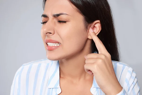 Emotional Young Woman Suffering Ear Pain Light Grey Background Closeup — Foto de Stock
