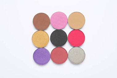 Beautiful eye shadow refill pans on white background, flat lay