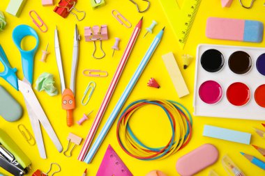 Flat lay composition with different school stationery on yellow background. Back to school