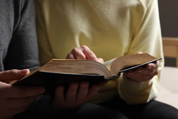 stock image Couple sitting and reading holy Bible indoors, closeup