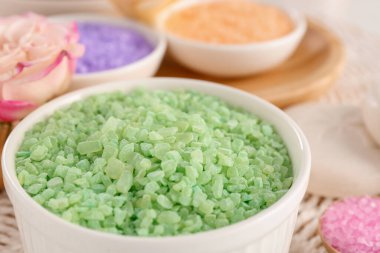 Bowl with sea salt on wicker mat, closeup
