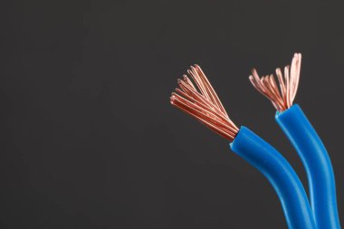 New colorful electrical wires on gray background, space for text