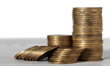Stack of coins on wooden table, closeup